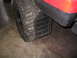 1989 Ford Bronco - Close-up view of a black mud flap and a large tire on the side of a red vehicle.