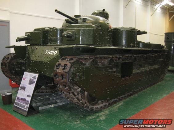 Green tank with riveted hull and tracks, marked T1020, displayed indoors