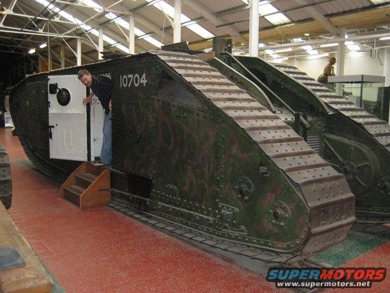 person peeking out of tank door, another tank visible