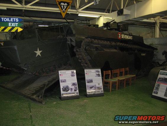Amphibious landing craft with "3 SEVENOAKS" on side, inside a museum