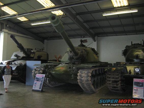 Tanks in a museum with display boards and a visitor