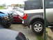 1994 Ford F-250 - Multiple vehicles are parked closely together, with one truck showing significant front-end damage.