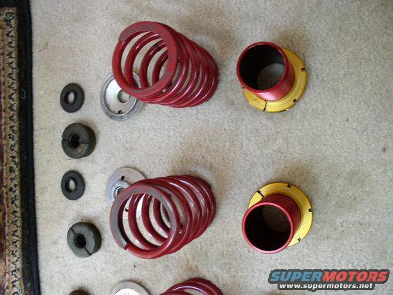 Red suspension springs and gold/red adjustable perches on carpet