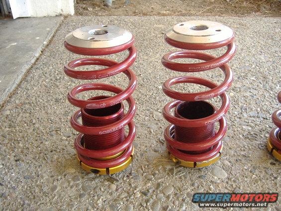 Pair of red Eibach suspension springs with gold adjusters