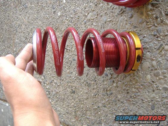 Red coilover suspension part with 'GROUND CONTROL' and 'GC180-5274' text