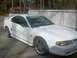1999 Ford Crown Victoria - A white Ford Mustang GT is parked outside a house with a white fence in the background.
