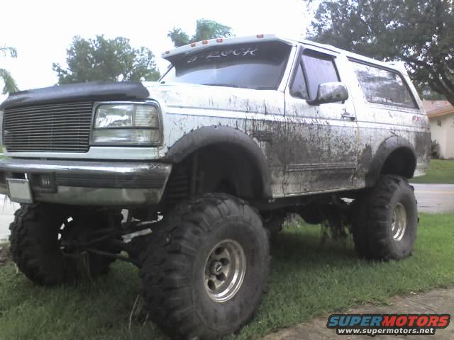 1995 Ford Bronco with large tires and mud splatter