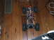 1996 Ford Bronco - The chassis of a remote control rock crawler sits on a wooden floor, showing its internal components.