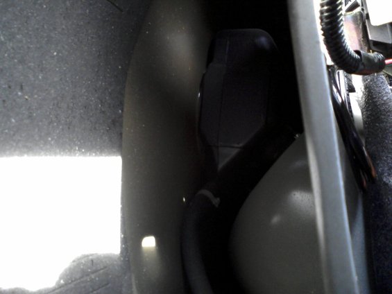 0930071605a.jpg The stock NON-remote release fuel filler door opening - as viewed from in the trunk, behind the carpeting - between the fender and trunk bracing