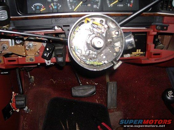 1987 Ford Bronco interior showing steering column disassembled, pedals, and dashboard gauges