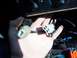 1994 Ford Probe - Close-up of a hand holding electrical connectors within a vehicle's dashboard area, with part of the climate control visible.