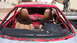 1996 Ford Probe - The interior of a red sports car is shown with its doors removed and the seats exposed.