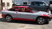 1996 Ford Probe - A car in primer and red is undergoing modifications, parked next to a pickup truck.