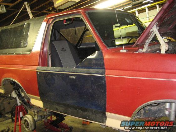 Ford Bronco side view, doors removed, hood up, in garage