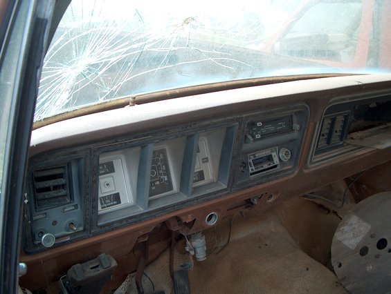 1979 Ford Bronco interior dashboard with cracked windshield and aftermarket radio