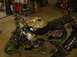 2002 Ford Mustang - A custom painted motorcycle sits in a workshop, with a person working in the background.