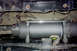1988 Ford Bronco - Close-up of a vehicle winch and its steel cable, mounted to the frame.
