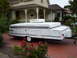 1995 Ford Bronco - A white pop-up camper trailer is parked on a red brick driveway in front of a house.