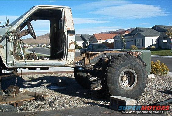 Truck cab and chassis with large tires, viewed from the side