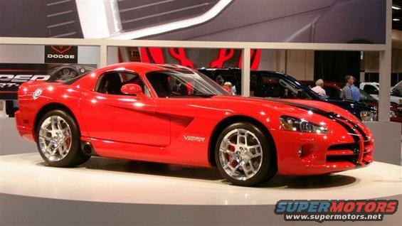 Red Dodge Viper with black racing stripes on display, side view