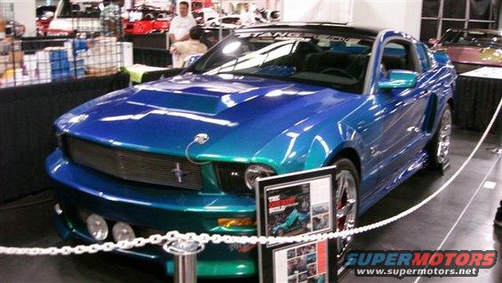 Blue and teal Ford Mustang with hood scoop and custom grille