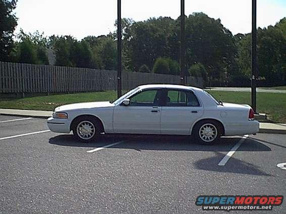 White 1998 Ford Crown Victoria sedan parked curbside