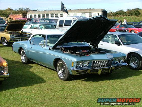 Light blue 1971 Buick Riviera coupe with hood open, showing engine