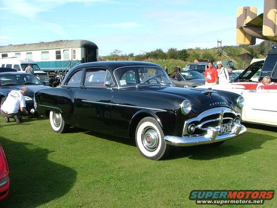 Black Packard sedan with whitewall tires and chrome grille