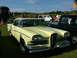1988 Ford Sport - Yellow 1958 Edsel Pacer sedan with a white roof, parked next to a black pickup truck.