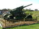 1988 Ford Sport - An anti-aircraft gun is displayed outdoors behind a protective barrier.