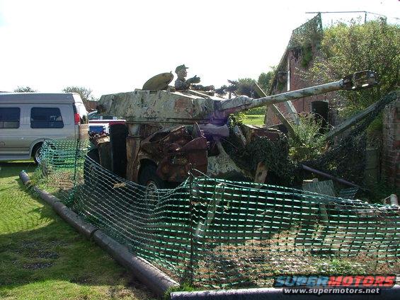 Tank with a van in the background