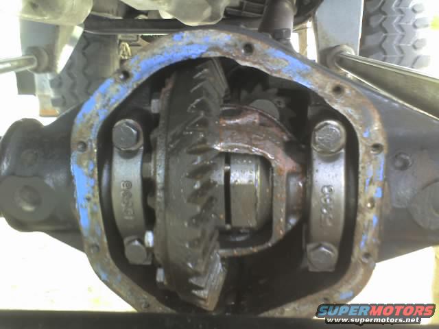 close-up of open differential housing with gears visible, blue paint on housing edge