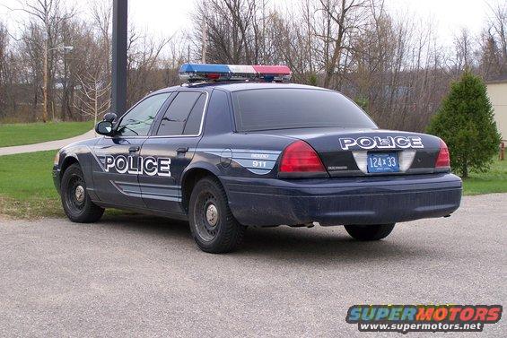 2003 Ford Crown Victoria police car, rear view. License plate 124x33