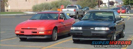 Red 1989 Ford Probe and black 1989 Mazda 626 parked side-by-side