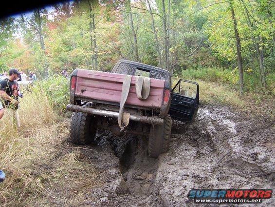 Off-road vehicle stuck in mud on a trail