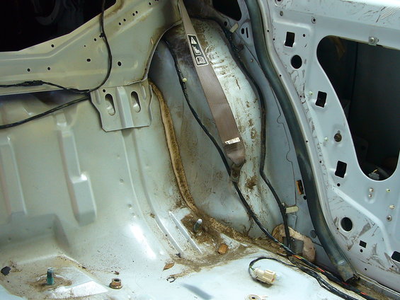 Car interior structural metal with rust and grime. Close-up view