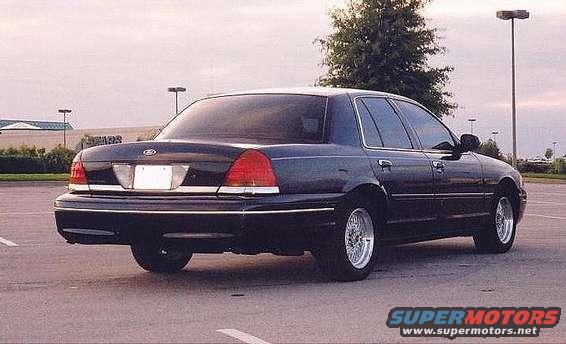 Dark blue Ford Crown Victoria parked in a lot, rear view
