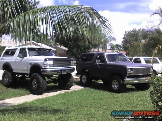 Black Ford Bronco with chrome grille and side mirrors, lifted on large tires