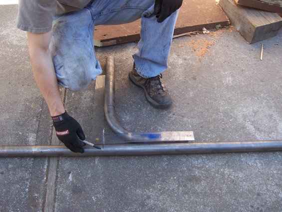 Person marking metal tube for fabrication of sliders