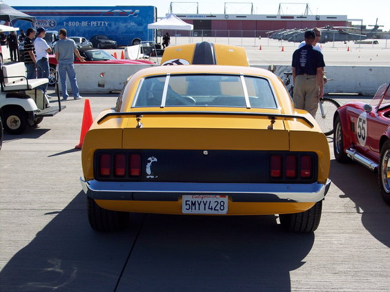 Yellow car's rear view, black stripe on hood, California license plate 5MYY428