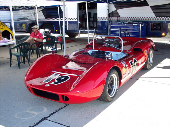 Red race car with number 79 on hood, 3/4 front view