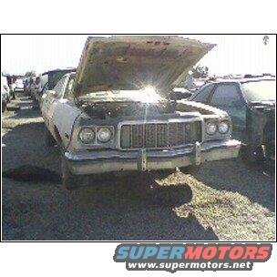 1973 Ford Ranchero with hood open, front view, in a junkyard