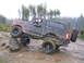 1989 Ford Bronco - Driver navigates a challenging off-road obstacle in a modified 1989 Ford Bronco.