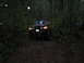1989 Ford Bronco - Red 1989 Ford Bronco navigates a wooded path during rainy weather.