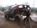 1989 Ford Bronco - Modified 1989 Ford Bronco tackling an off-road trail with a large tree stump obstacle.