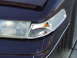 1992 Ford Crown Victoria - Close-up of the front passenger side headlight and grille area of a 1992 Ford Crown Victoria.