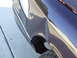 1992 Ford Crown Victoria - The rear fender of a car shows significant damage, with a tire visible below.