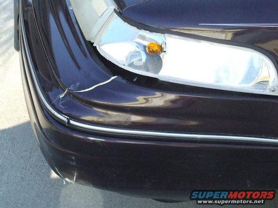 Dark purple 1992 Ford Crown Victoria front bumper with damage and chrome trim