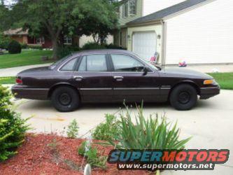 1992 Ford Crown Victoria sedan, side view, dark color, black wheels