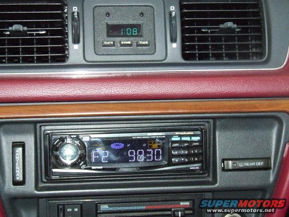 1992 Ford Crown Victoria interior dashboard with digital clock, aftermarket stereo, and air vents